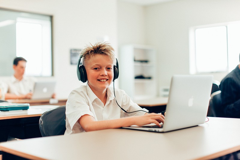 Year 7 student from Somerset wearing headphones while using laptop