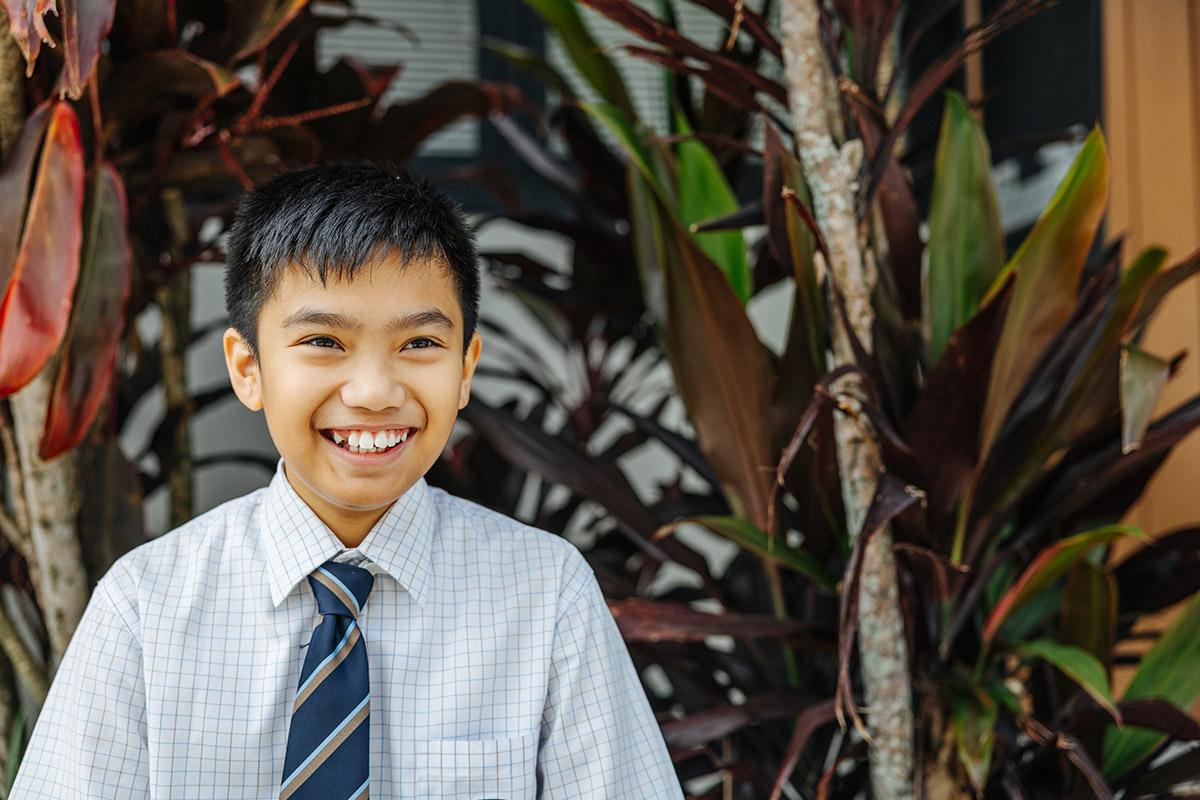 Primary student playing on school playground equipment at ACC Moreton.