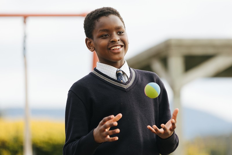 ACC Benalla student wearing jumper and tossing ball