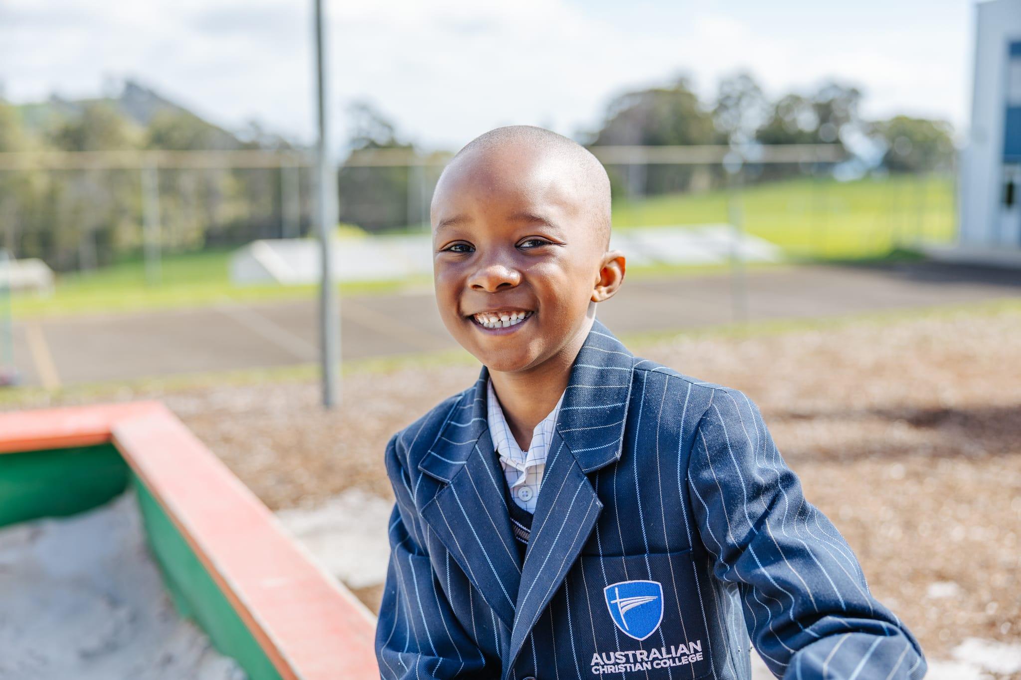 Primary boy smiling at the playground at Australian Christian College Burnie