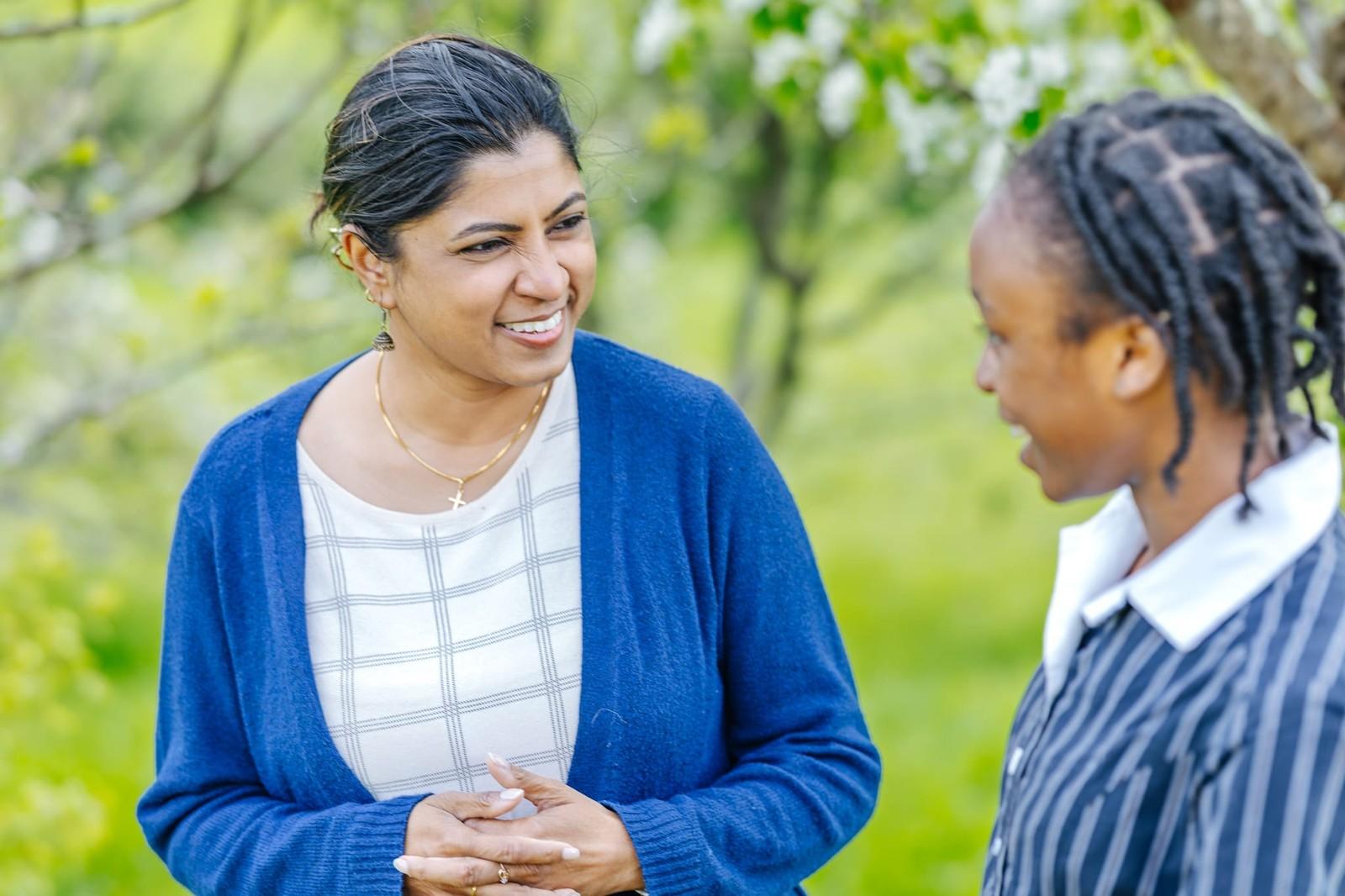 A teacher chatting warmly with a student in the school grounds at ACC Burnie, Somerset.